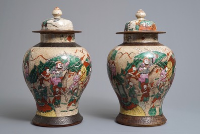 A pair of Chinese Nanking famille rose vases and covers with warriors, 19/20th C.