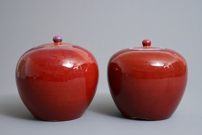 A pair of Chinese monochrome oxblood-glazed jars and covers, 19th C.