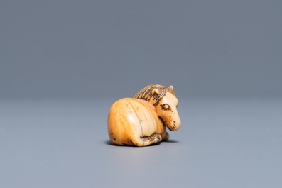 A Japanese ivory 'recumbent horse' netsuke, Edo, 18/19th C.