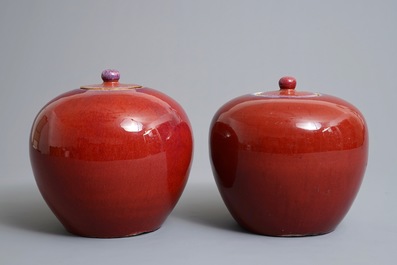 A pair of Chinese monochrome oxblood-glazed jars and covers, 19th C.