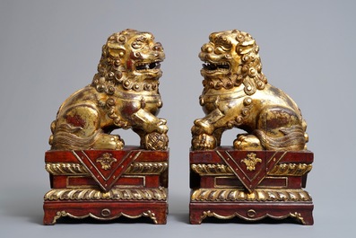 A pair of Chinese gilt-laquered wood Buddhist lions, 19th C.