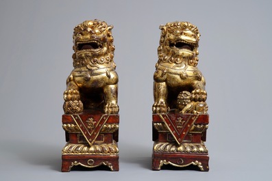 A pair of Chinese gilt-laquered wood Buddhist lions, 19th C.