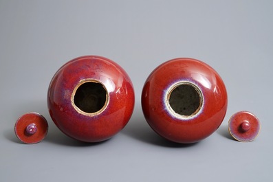 A pair of Chinese monochrome oxblood-glazed jars and covers, 19th C.