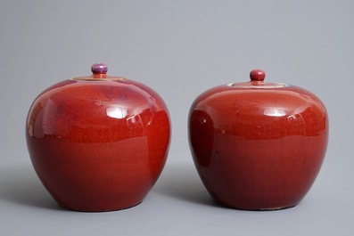 A pair of Chinese monochrome oxblood-glazed jars and covers, 19th C.