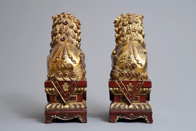 A pair of Chinese gilt-laquered wood Buddhist lions, 19th C.