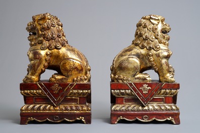 A pair of Chinese gilt-laquered wood Buddhist lions, 19th C.