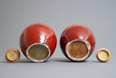 A pair of Chinese monochrome oxblood-glazed jars and covers, 19th C.