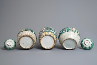Three Chinese famille rose jars and covers and two bowls, 19th C.
