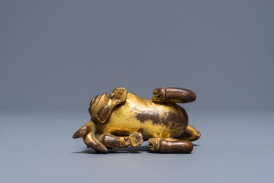 A Chinese gilt bronze scroll or paper weight in the form of a ram, 19/20th C.