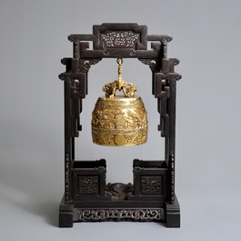 A Chinese gilt bronze bell in zitan suspension frame, Qianlong mark, 18/19th C.