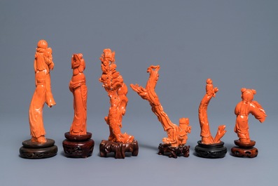 Six Chinese carved coral figures on wooden stands, 19/20th C.