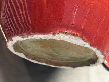 A pair of Chinese monochrome oxblood-glazed jars and covers, 19th C.