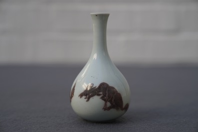 A Chinese copper-red bottle vase with mythical creatures, Kangxi