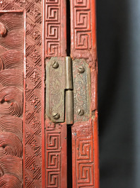 A Chinese cinnabar 'dragons and phoenixes' lacquer cabinet, 19th C.