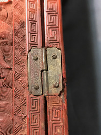 A Chinese cinnabar 'dragons and phoenixes' lacquer cabinet, 19th C.