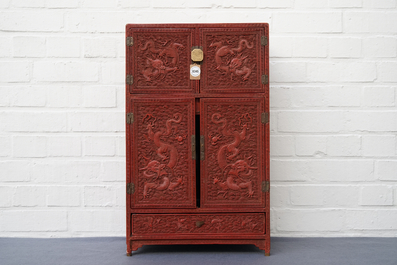 A Chinese cinnabar 'dragons and phoenixes' lacquer cabinet, 19th C.