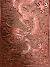 A Chinese cinnabar 'dragons and phoenixes' lacquer cabinet, 19th C.