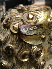A pair of Chinese gilt-laquered wood Buddhist lions, 19th C.