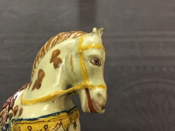 A pair of polychrome Dutch Delft lime-green ground models of circus horses, 19th C.