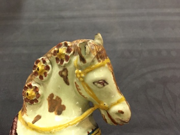 A pair of polychrome Dutch Delft lime-green ground models of circus horses, 19th C.
