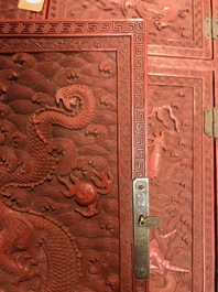 A Chinese cinnabar 'dragons and phoenixes' lacquer cabinet, 19th C.