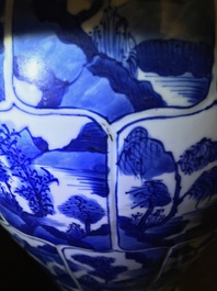 A pair of Chinese blue and white vases and covers with landscape panels, Kangxi