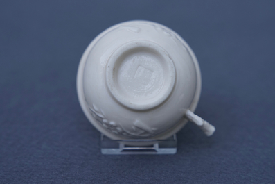 A Chinese Dehua blanc de Chine cup with applied design, seal mark, Kangxi