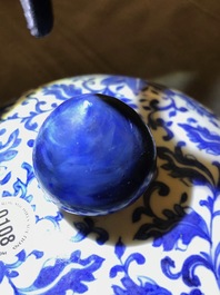 A Chinese blue and white 'lotus scroll' vase and cover, 19th C.