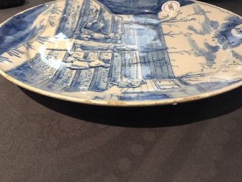 A Dutch Delft blue and white plate with peasants from the 'Zodiac' series, first quarter 18th C.