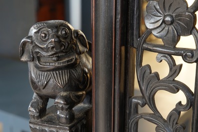 A large Chinese carved zitan wood panel with jade and turquoise, set in a hongmu wood frame and stand, Qianlong