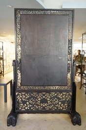 A large Chinese carved zitan wood panel with jade and turquoise, set in a hongmu wood frame and stand, Qianlong