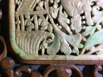 A small Chinese jade plaque mounted in a carved wood table screen, 19/20th C.