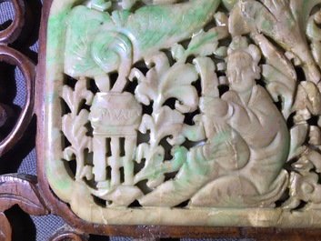 A small Chinese jade plaque mounted in a carved wood table screen, 19/20th C.