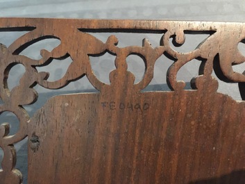 A small Chinese jade plaque mounted in a carved wood table screen, 19/20th C.