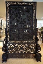 A large Chinese carved zitan wood panel with jade and turquoise, set in a hongmu wood frame and stand, Qianlong