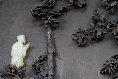 A large Chinese carved zitan wood panel with jade and turquoise, set in a hongmu wood frame and stand, Qianlong