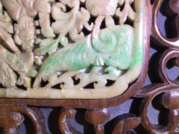 A small Chinese jade plaque mounted in a carved wood table screen, 19/20th C.