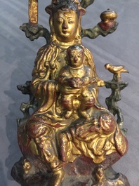 A Chinese gilt-lacquered bronze group of Guanyin with a child, 18th C.