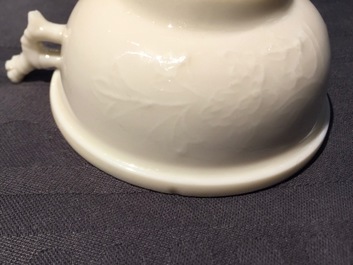 A Chinese Dehua blanc de Chine cup with applied design, Kangxi