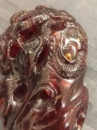 A Chinese carved amber group of a tiger below a pine tree and a dragon, 19/20th C.