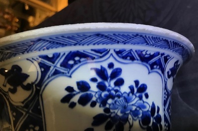 A large Chinese blue and white three-piece garniture with landscape and floral panels, Kangxi