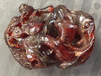 A Chinese carved amber group of a tiger below a pine tree and a dragon, 19/20th C.