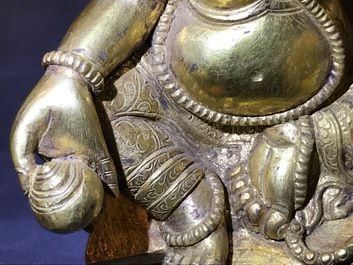 A Sino-Tibetan gilt bronze figure of Jambhala, 19/20th C.