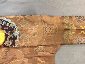 A Chinese brown ground eight-dragon embroidered silk robe, Qianlong