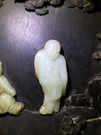 A large Chinese carved zitan wood panel with jade and turquoise, set in a hongmu wood frame and stand, Qianlong