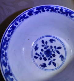 A pair of Chinese blue and white French market cups and saucers with texts, Kangxi