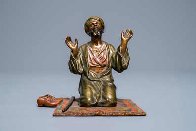A cold-painted bronze group of a praying muslim, Vienna, signed Bergman, late 19th C.
