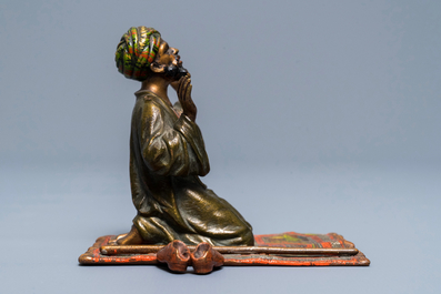 A cold-painted bronze group of a praying muslim, Vienna, signed Bergman, late 19th C.