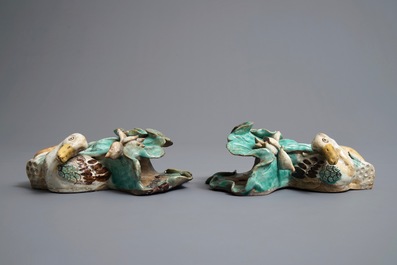 A pair of Chinese Shiwan wall pocket vases with ducks among lotus flowers, 19th C.