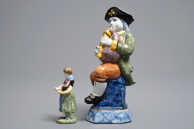Two polychrome Dutch Delft models of a bagpipe player and a lady, 19th C.